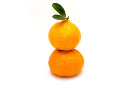 A stack of Orange with leaves isolated on white background.