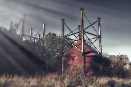 Rusty Red Industrial Oil Storage Tanks Lightraysの写真素材