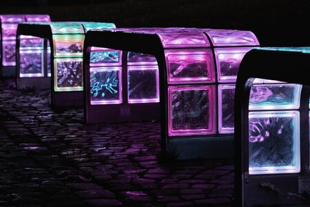 Luminous colorful bench in a dark nightの写真素材