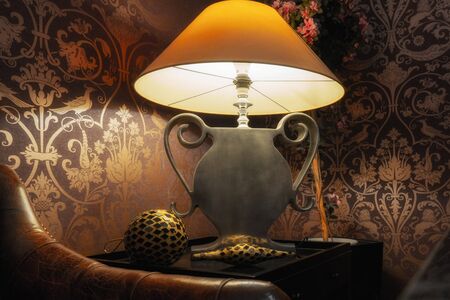 Yellow Shade, Silver Foot Lamp in Vintage Environment with Leather Sofa in Frontの写真素材