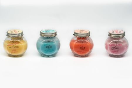 Four Color Sorted Candles in Glass with Screw Cap on white Backgroundの写真素材