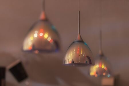 Three Colorful pendant lights with beautiful bokehの写真素材