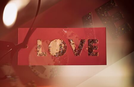 Red sign saying love and colored particlesの写真素材