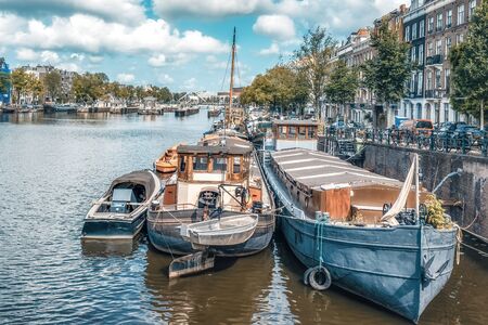 Dutch boat in the canal is docked next to a body of waterの写真素材