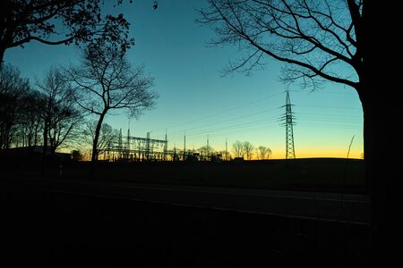 Silhouette of an early morning substation at sunriseの写真素材
