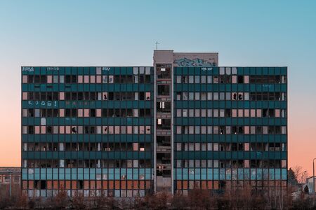 Abandoned building with broken windows and graffiti tagsの写真素材