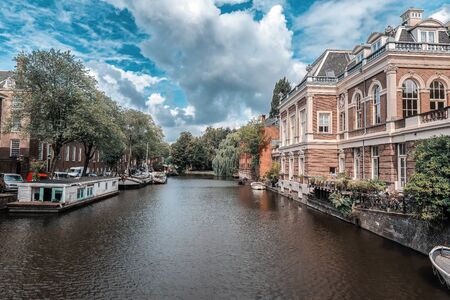Dutch waterway in Amsterdam with a dramatic Skyの写真素材