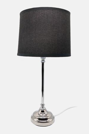 A modern floor lamp with a black lampshade and chrome-colored baseの写真素材