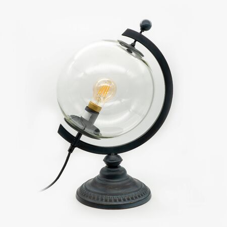 A glass globe lamp with a metal base, cut out on white backgroundの写真素材