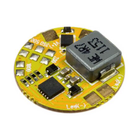 Yellow round led driver PCB board with inductance coil and surface mount components in a close-up viewの写真素材