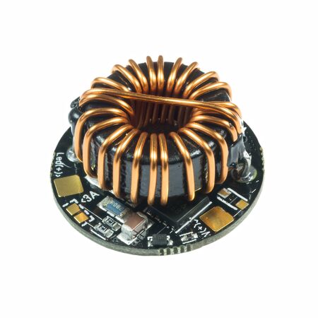 Black round led driver PCB board with inductance coil and surface mount components in a close-up viewの写真素材