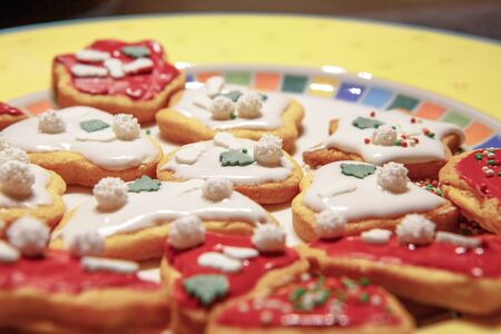 A close up of a plate of colorful Christmas cookiesの写真素材