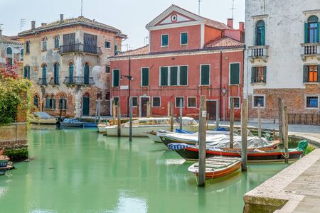Small boats stand in the middle of Venice at a dockの写真素材