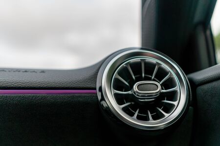 A close up of a ventilation nozzle in a modern sport carの写真素材