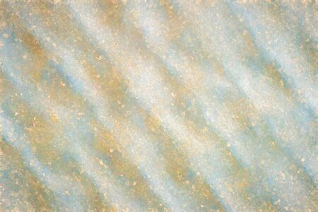 Macro shot of a wavy structure and round pigment-like yellow blobs of paintの写真素材