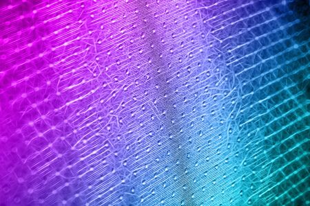 Macro shot of a reticulated, wavy pink-blue surface made up of small flashesの写真素材