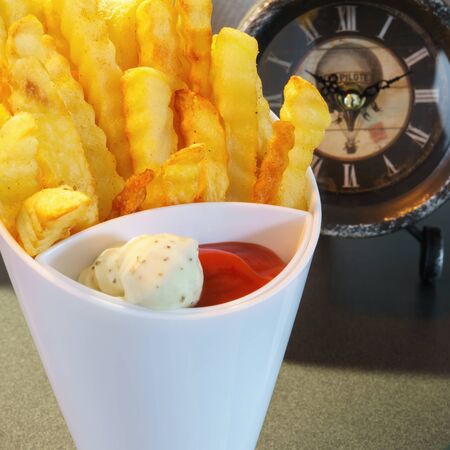 A white high top with french fries, ketchup and mayonnaise, close upの写真素材