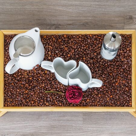 An arrangement of heart cups on a tray with coffee beansの写真素材