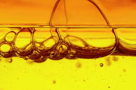 A viscous yellow liquid with air bubbles, macro shotの写真素材
