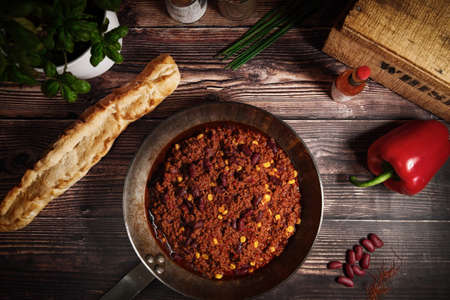 In a cast iron pan with freshly baked bread on a wooden surfaceの写真素材