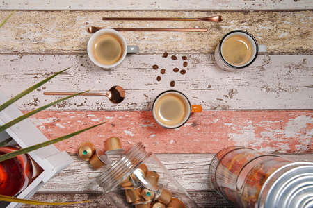 Three colorful cappuccino cups stand on a decorating tableの写真素材