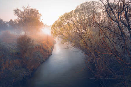 A beautiful orange sunset on a small river, dreamy atmosphereの写真素材
