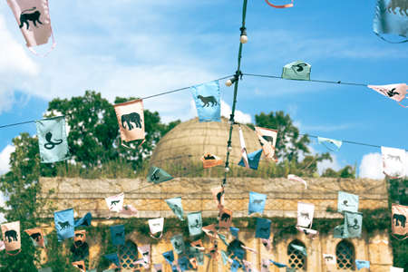 Indian prayer flags hang strung in the airの写真素材