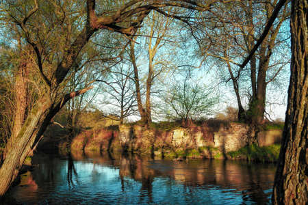 A small river with natural rock walls at sunsetの写真素材