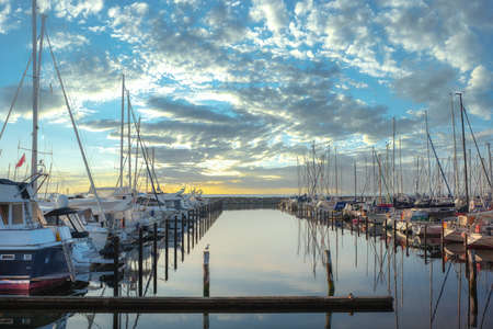 Boat jetty with yachts on a pier in the morningの写真素材