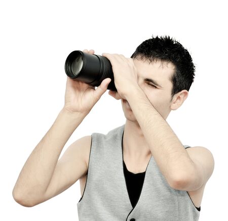 Young man looking through the lensの写真素材