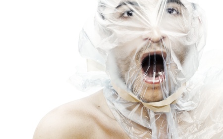 Young man with a bag on his head trying to breathe-NOTE:Some grain was added for composition effectの写真素材