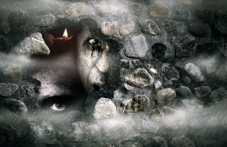 Halloween concept  of a broken stone wall with zombiesの写真素材