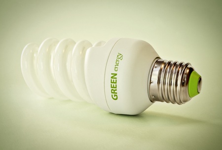 Close up of a light bulb on green backgroundの写真素材