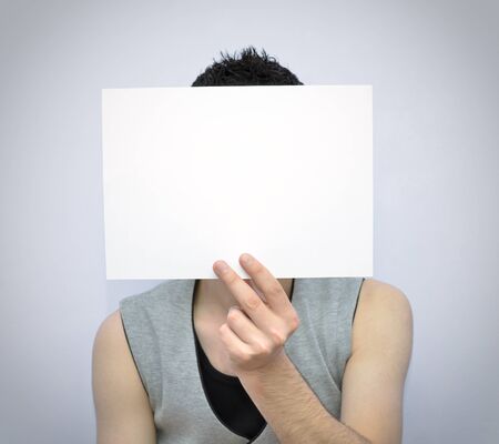 Young man holding a blank cardの写真素材