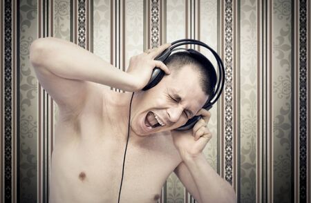 Young man enjoying music on headphonesの写真素材