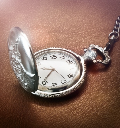 Close up of a pocket watch on brown textureの写真素材