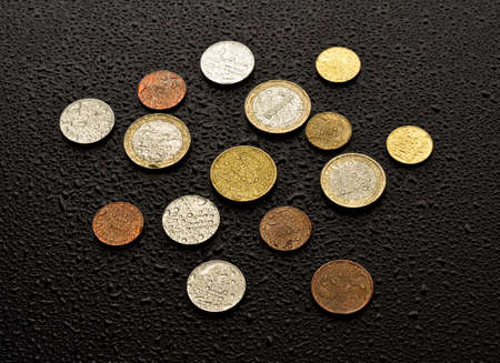 Coins on black wood backgroundの写真素材