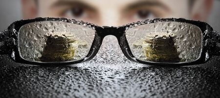 Young businessman looking at glassesの写真素材