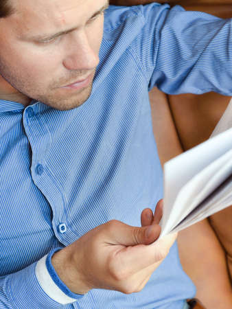 Young man analyzing a business reportの写真素材