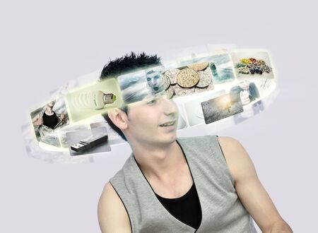 Young man looking at virtual photosの写真素材