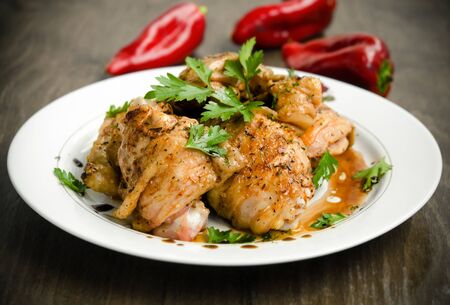 Grilled chicken breast with pepper sauce against wooden backgroundの写真素材