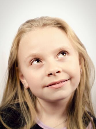 Little girl looking up and smillingの写真素材