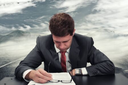 Young man at office reading an application formの写真素材