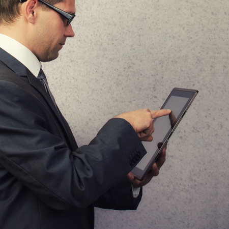 Businessman holding and working on digital tabletの写真素材