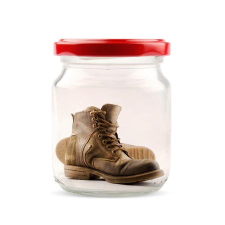 Pair of boots closed in a jar on white backgroundの写真素材