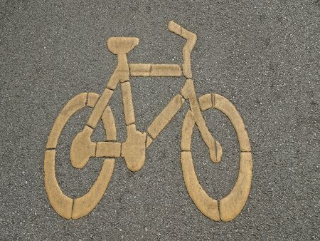 bike sign on surface of street in park