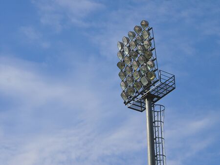 football stadium floodlight in blue sky and white cloud