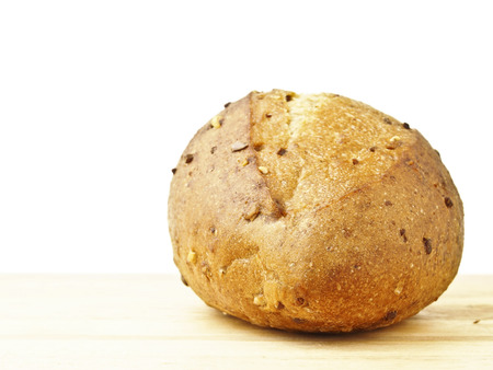 kraftkorn bread on wood floor in white background