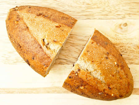cutting big kraftkorn bread on chopping wood