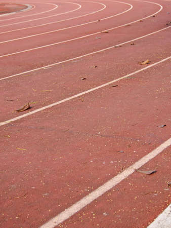 straight lanes of running track in sunlight